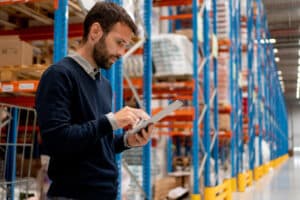 Manager holding digital tablet in warehouse